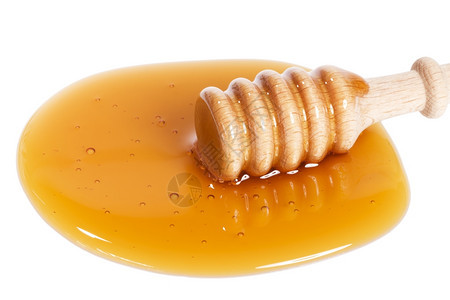 金的蜂蜜在一小堆中从稍高的顶端在白色背景的蜂蜜中早餐蘸图片