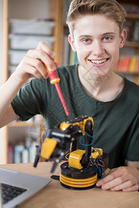学习校内青少年男孩建造机器人臂的肖像学校白种人图片