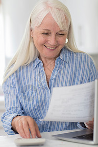 审查国内金融的微笑期妇女人数家庭财政审查白种人笔记本电脑在室内图片