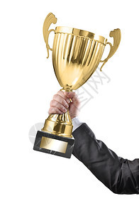 商人持有一个冠军金奖杯在白底的背景仪式成就胜利图片