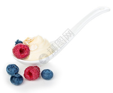 麦片牛奶油白纸上孤立的松果和蓝莓酸奶图片