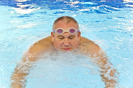 欧洲的大胖子在游泳池里玩运动蓝色的五十图片