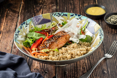 晚餐吃棕碗上加奎诺亚沙拉的灰鲑鱼蛋白质图片