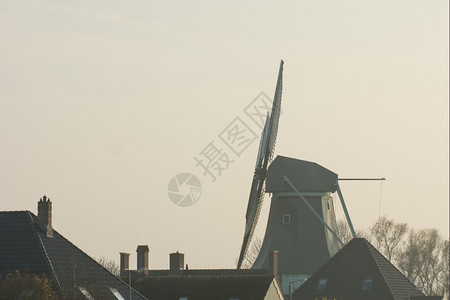 田园诗般的日落与古老荷兰风车场景水平的图片