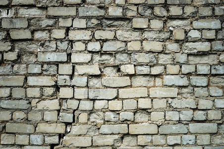 材料邋遢质地旧裂破白砖墙的背景图片