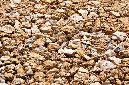 简单黑色的Brown建筑工地砂砾石背景大型石头被重机械压平巨石图片