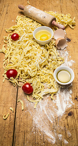 意大利语木制的面粉鸡蛋和盐的西红柿意大利面加粉木制生锈背景最接近的顶端视图素食主义者图片