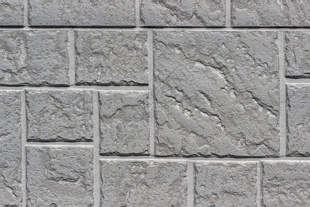 以灰色度为背景或纹理的雕塑砖墙几何形态的人工石块接近设计概念内部的一种外图片