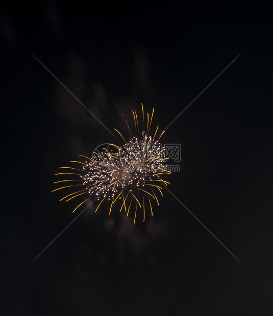 午夜新年节的金色心脏火花烟明亮的爆裂图片