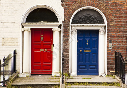 在都柏林两扇漆着的门并肩站在一起提供色彩多的景象红蓝门由传统和白洗的砖墙支撑反之则有趣具体的传统拉根图片