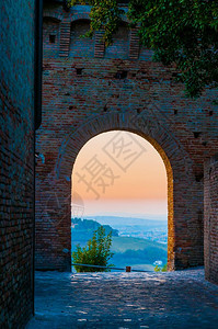 塔优质的老在意大利中世纪小镇格拉达的一个拱门上看到软日落图片