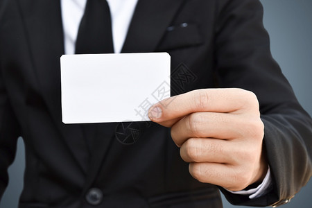 参观广告套装在黑西Idea上展示一张白纸的商人以获得业信用卡或访客图片