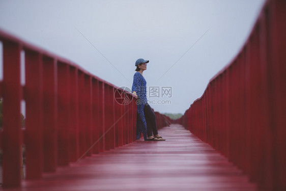 出差码头年轻女站在红木桥上泰国模型图片