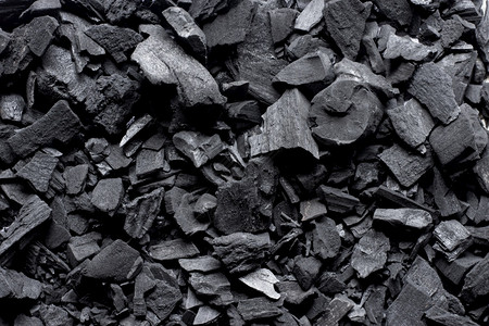 治疗温泉关心很多黑炭堆积起来木炭背景图片
