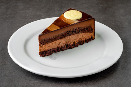 庆祝巧克力蛋糕在白瓷板上孤立的白色背景上吃奏鸣曲甜的图片