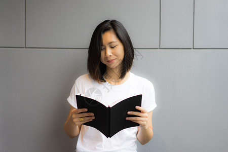 漂亮的成人亚洲年轻裔女阅读快乐图片