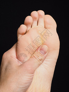 脚下压力点按摩用拇指向黑色偏移美丽的愈伤组织图片