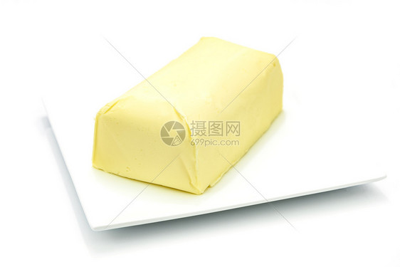 有机的盘子上新鲜有机黄油的一块小以白色背景隔绝的面包图片