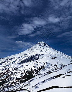 岩石生态的在堪察卡有雪火山维柳欣斯基和蓝天空的景象高背景图片