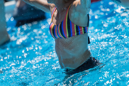 妇女在游泳池户外进行水中有氧运动妇女在游泳池户外进行水中有氧运动女央积极的图片