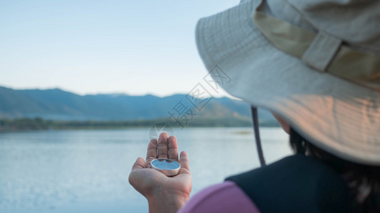 女士保持磁的活动冒险背景指南针方向发现设备探索险家女查找森林gps手帽子徒步旅行者远足举旅程湖休闲生活方式位置寻找丢失磁山自然导图片