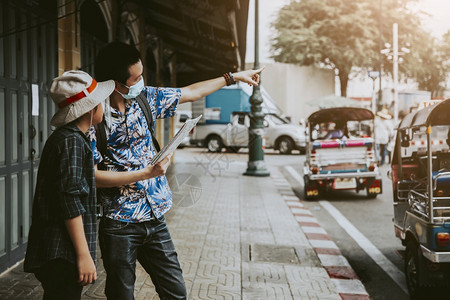 亚洲旅行者使用指南度假计划日和旅行概念的游者年轻的时尚包背景