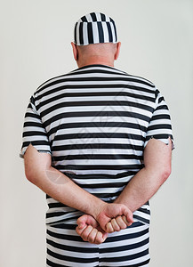 一名囚犯在监狱长袍上的肖像后部入狱外衣图片