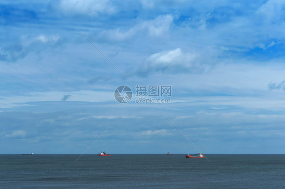 生产原油海上石钻探地平线上海的船只平静而多云的天空地平线上的海船只石油钻井平静而多云的天空工人图片