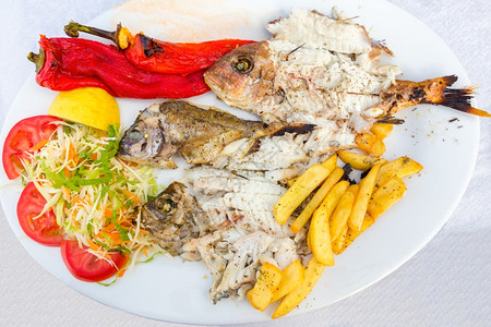 饮食地中海菜单鱼薯条和盘蔬菜热的柠檬图片