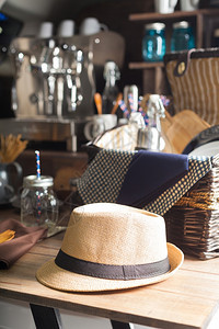 坐在木制桌边的帽子野餐篮和背景里的咖啡机桌子优质的铝图片