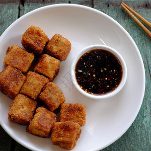 越南烹饪的节食素品有香料力的油豆腐面粉薄煎绿叶背景的自制食物素大豆酱和吃美味的木制图片