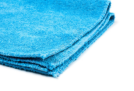 棉布折叠纺织品白色上隔离的蓝显微纤维扫尘器图片