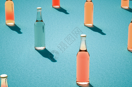 寒冷的几个玻璃啤酒瓶有浅蓝色背景的阴影各种没有标签的彩色玻璃瓶Retro饮料瓶概念反射照片图片