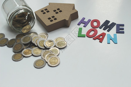买为了经济HomeLOAN抵押贷款和有复制空间的泰国地产硬币概念图片