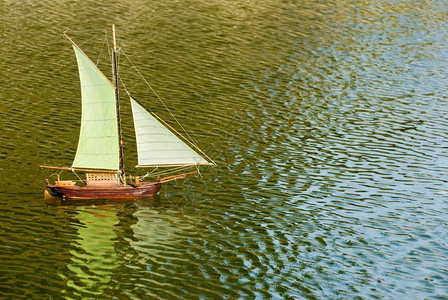 单身的湖上装有反射手制遥控帆船戏剧爱好图片