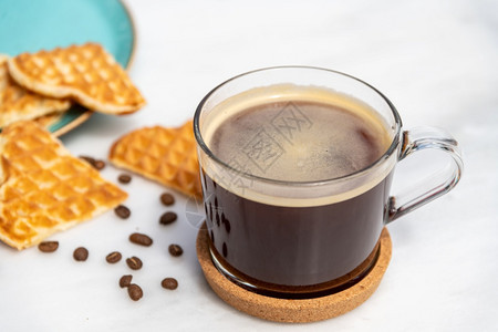 浓咖啡因大理石桌上玻璃咖啡杯中的新鲜美式咖啡热的图片