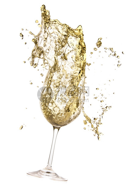 高脚杯诱人的白葡萄酒喷洒在色庆祝图片