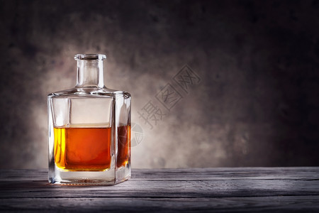 酒精朗姆深色背景中的方形白兰地酒瓶方形白兰地酒瓶玻璃图片