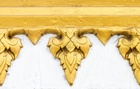 抽象的泰国寺庙大理石墙上的金色花朵图案东方的古董图片