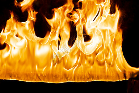 运动抽象艺术黑色背景的火焰燃烧红色热火花上升烈橙光闪耀的飞行粒子温暖热图片