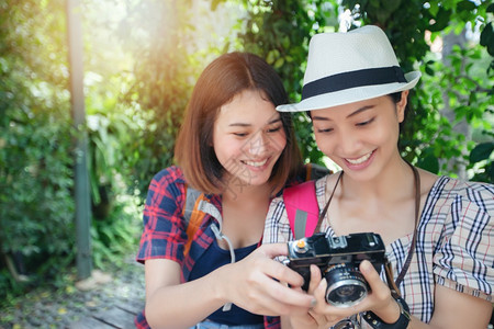 远足年轻的旅游亚洲女背包一起走来去欢乐地拍着照片和观光在假日概念旅行上放松时间图片