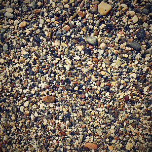 海滨具有小宝石的抽象多彩背景石质光滑的图片