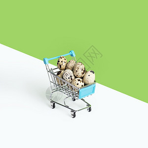 手推车顾客电子商务玩具超市汽车或电装满在绿色背景上隔绝的蛋玩具超市汽车或电装满在绿色背景上隔绝的鹌鹑蛋图片