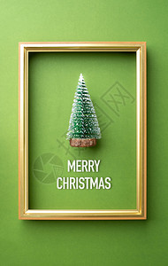 圣诞快乐贺心绿的圣诞树配有绿色奢华背景生活节庆祝概念的金框架喜庆的标题绿卡背景图片