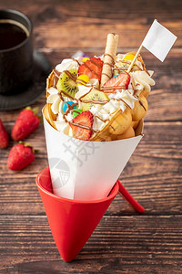 香草新鲜的带冰淇淋水果巧克力酱和多彩糖果的红公或泡松饼奏鸣曲图片
