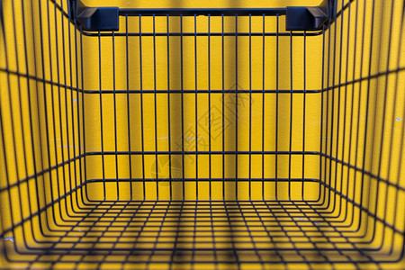 颜色在超市购物车黑色和黄墙壁的最小化风格型的携带图片