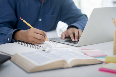 年轻的聪明连接使用计算机和移动设备学习在线教育和学习的青年拼图生使用计算机和移动设备图片