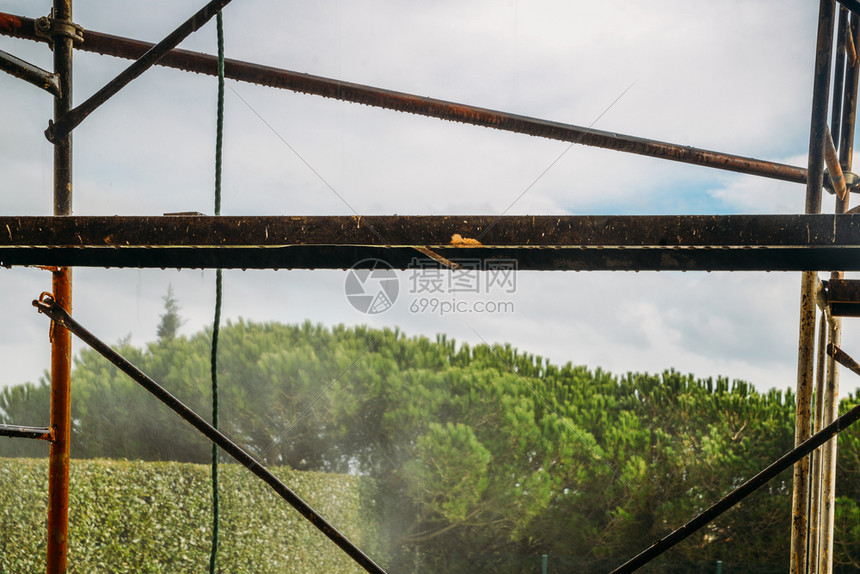 行业承包商颜色在建筑物一侧用喷水洒的脚手架在建筑物室外视线旁的墙壁上图片