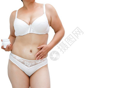 分数肥胖身穿白内裤超重妇女对腹部和大腿施奶油美丽图片