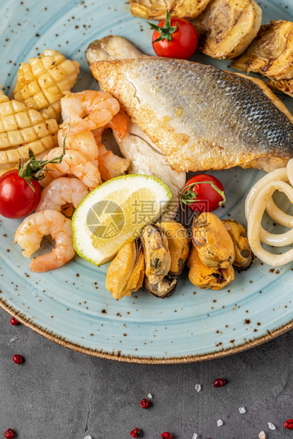 晚餐拼盘混合海鲜包括鱼鱿章贝类和虾蔬菜图片